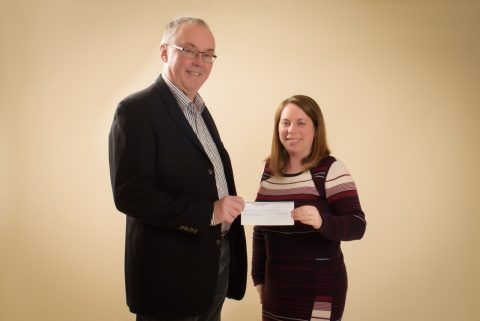 Mary Jane Howard hands a cheque to CPABC board member Jim Brookes for the proceeds of a photography fundraiser.